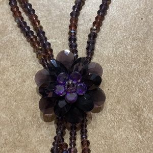 Purple beaded flower necklace.